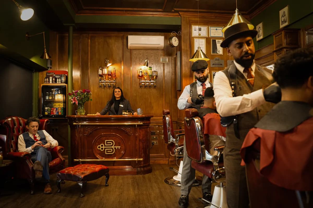 The Boardroom floor — barbers at work, the reception and the spirits wall