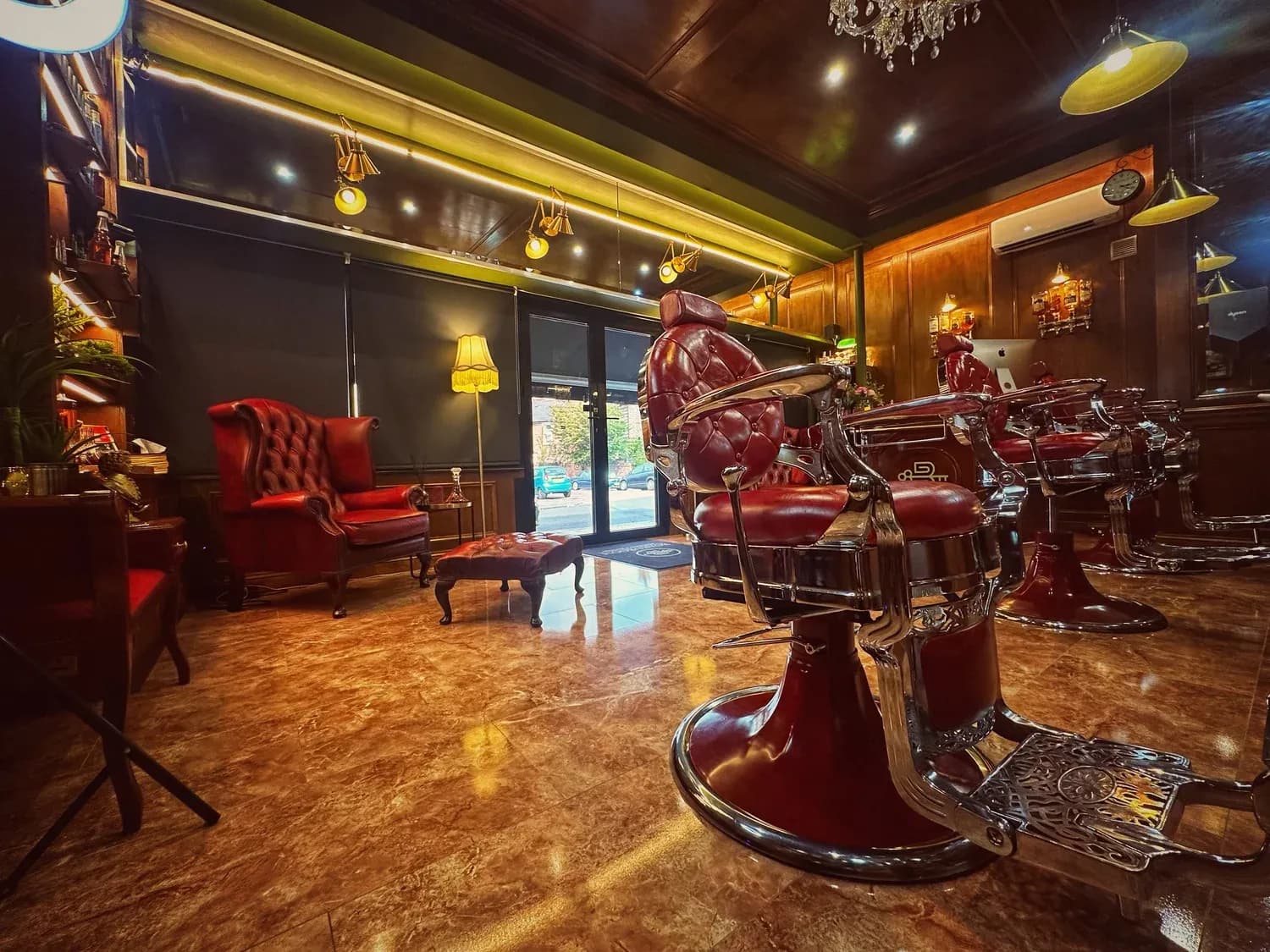 The Boardroom floor — barber chairs, Chesterfields and brass fittings