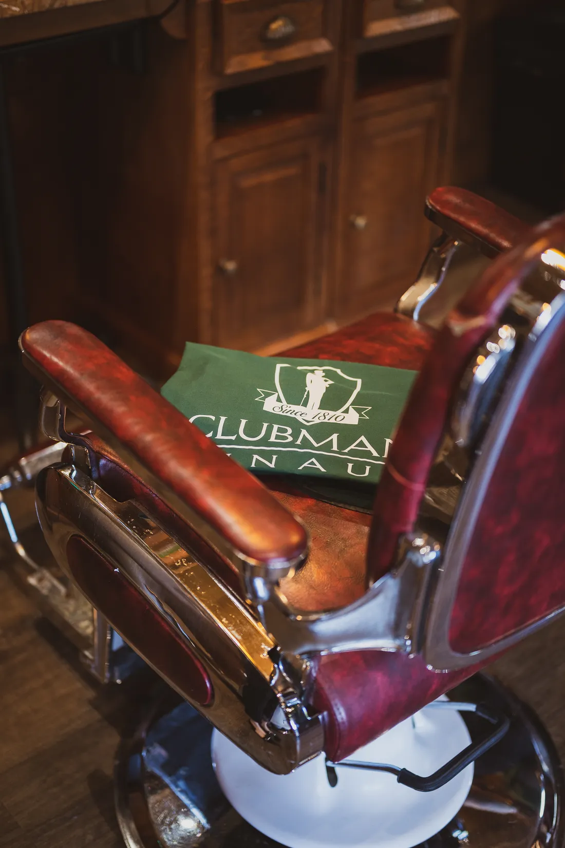 A vintage barber chair with a Clubman towel at the Boardroom